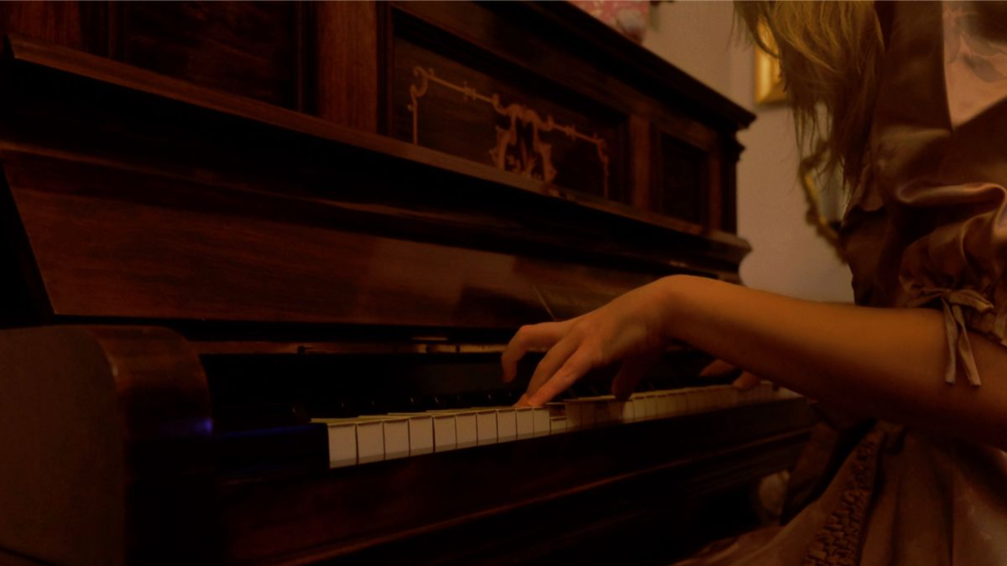 Close-up of hands playing a piano, representing mindful practice habits that help musicians improve